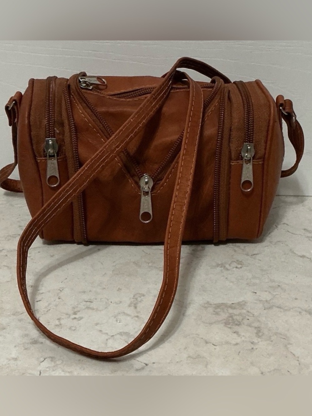 Brown Leather Concertible Barrel Crossbody Bag. Expandable